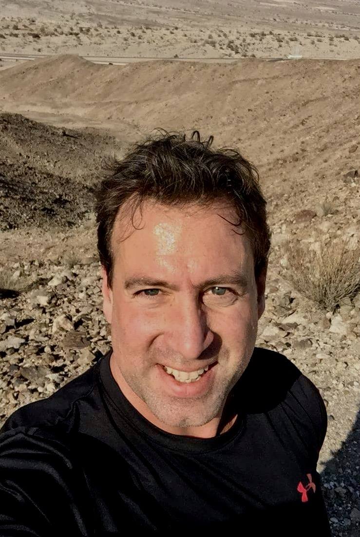 Dr. Roges hiking in the desert